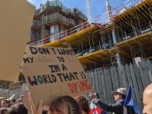 Photo of a sign that says "I don't want my children living in a world that's slowly dying"